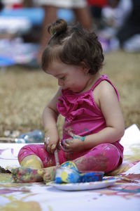 Portrait of cute girl sitting outdoors