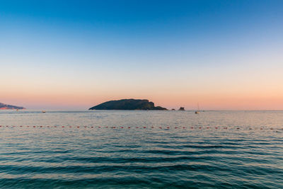 Scenic view of sea against clear sky during sunset