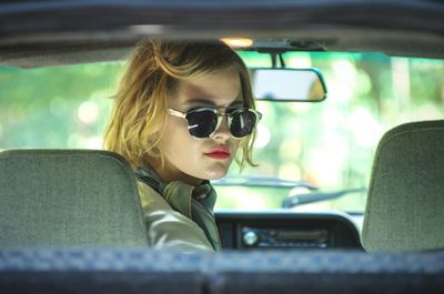 Portrait of woman sitting in car