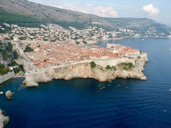 High angle view of townscape by sea