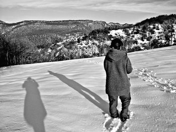 Full length of woman standing on mountain