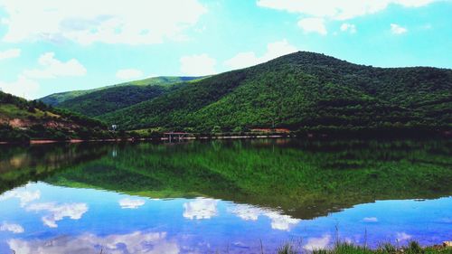 Scenic view of lake and mountains against sky