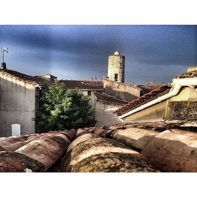 architecture, built structure, building exterior, transfer print, auto post production filter, sky, cloud - sky, stone wall, roof, house, old, day, cloud, outdoors, low angle view, wall - building feature, history, no people, cloudy, brick wall