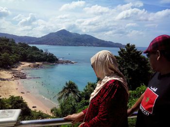 Rear view of woman looking at sea against sky