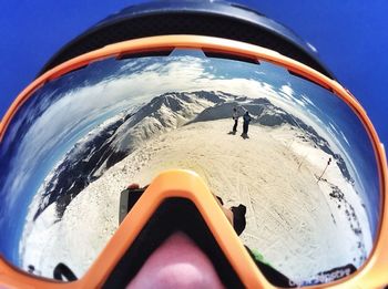 Cropped image of mountain against blue sky