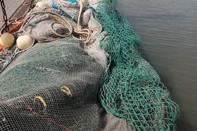 High angle view of fishing net in boat on sea