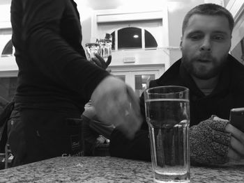 Close-up of man drinking beer in bar