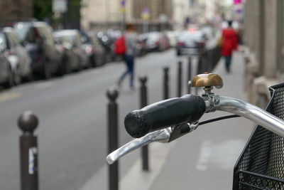Cropped image of bicycle handle in city