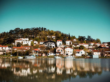 Buildings in town against clear blue sky