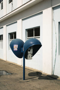 Telephones against building in city