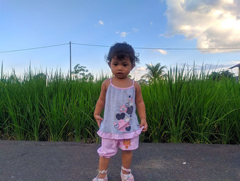 Full length of girl standing on grass