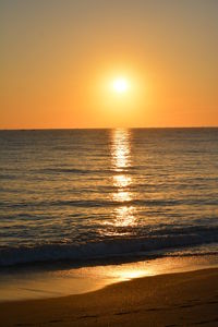 Scenic view of sea against romantic sky at sunset