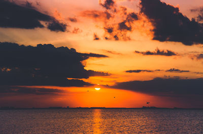 Scenic view of sea against orange sky