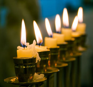 Close-up of lit candles on table