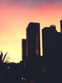 Low angle view of buildings against sky at sunset