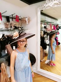 Full length portrait of woman standing in store