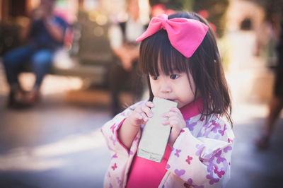 Close-up of girl holding packet