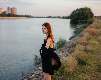 Portrait of young woman standing in water