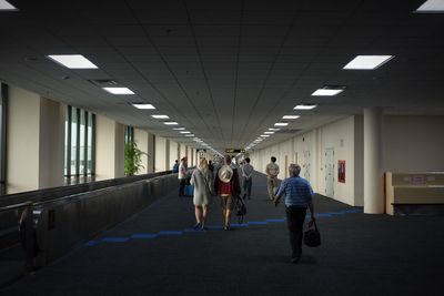 People walking in corridor of building