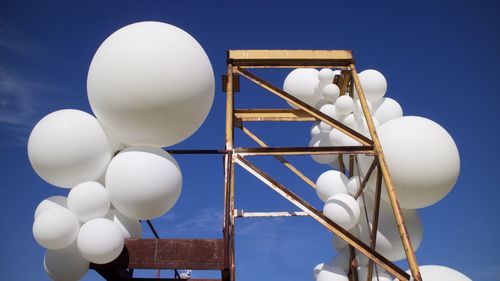 Low angle view of balloons against sky