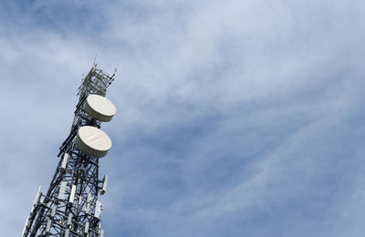 Low angle view of communications tower against sky