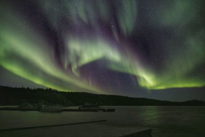 Scenic view of lake against sky at night