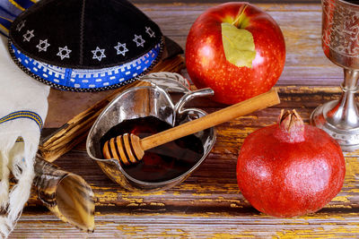 Shofar and tallit with glass honey jar and fresh ripe apples. jewesh new year symbols. rosh hashanah