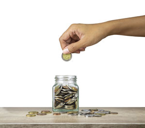 Person hand holding umbrella against white background