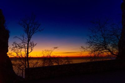 Silhouette bare trees against sky during sunset