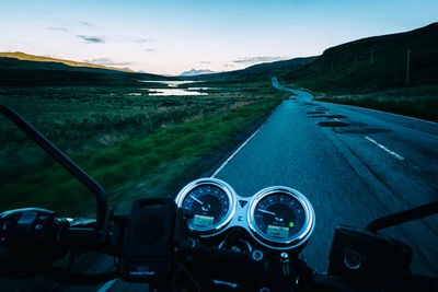 Helm of a motorcycle while driving on a lonely highway in beautiful scotland at dusk 