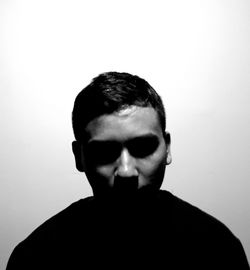 Close-up portrait of young man against white background