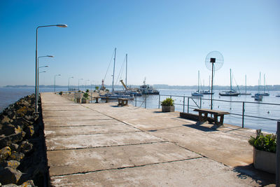 Scenic view of port and sea against sky