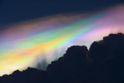 Low angle view of rainbow against sky at sunset