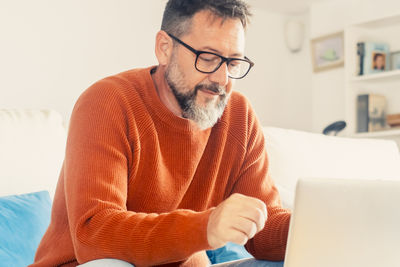 Young man using laptop at home