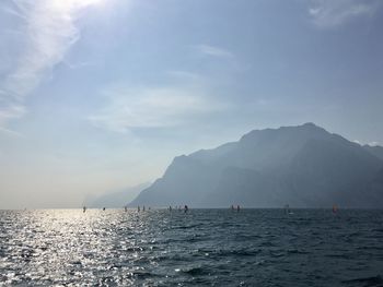 Scenic view of sea and mountains against sky