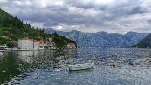 Scenic view of lake and buildings against sky