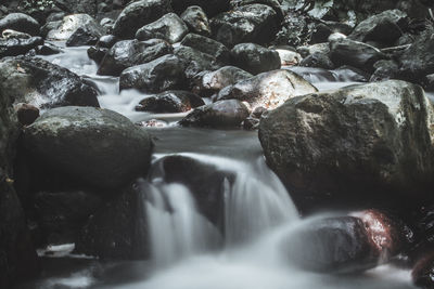 Close-up of pebbles in water