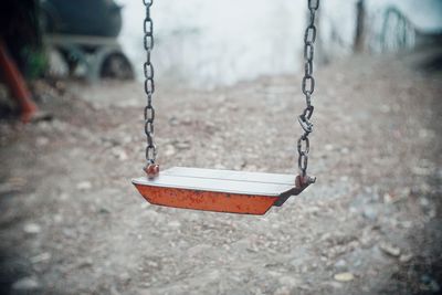 Close-up of empty swing in park