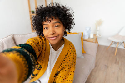 Portrait of young woman sitting on table