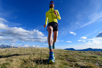 Mountain runner in a meadow trains for a marathon