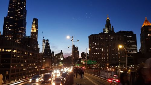 Illuminated city street and buildings at night