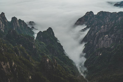 Scenic view of waterfall against sky