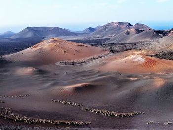 Scenic view of desert against sky, timanfaya national park, lanzarote