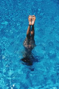 High angle view of young woman swimming in pool