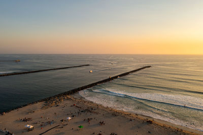 Scenic view of sea against clear sky during sunset