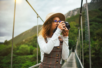 Full length of woman wearing sunglasses standing outdoors