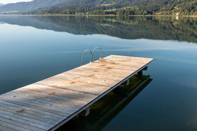 Pier on swimming pool by lake