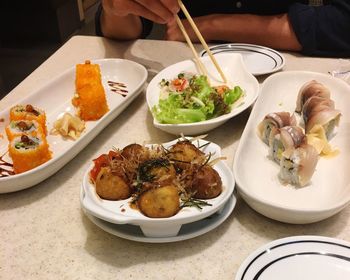 Midsection of man having food at table