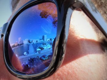 Reflection of sky on side-view mirror of car