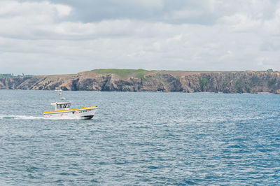 Boat sailing in sea against sky